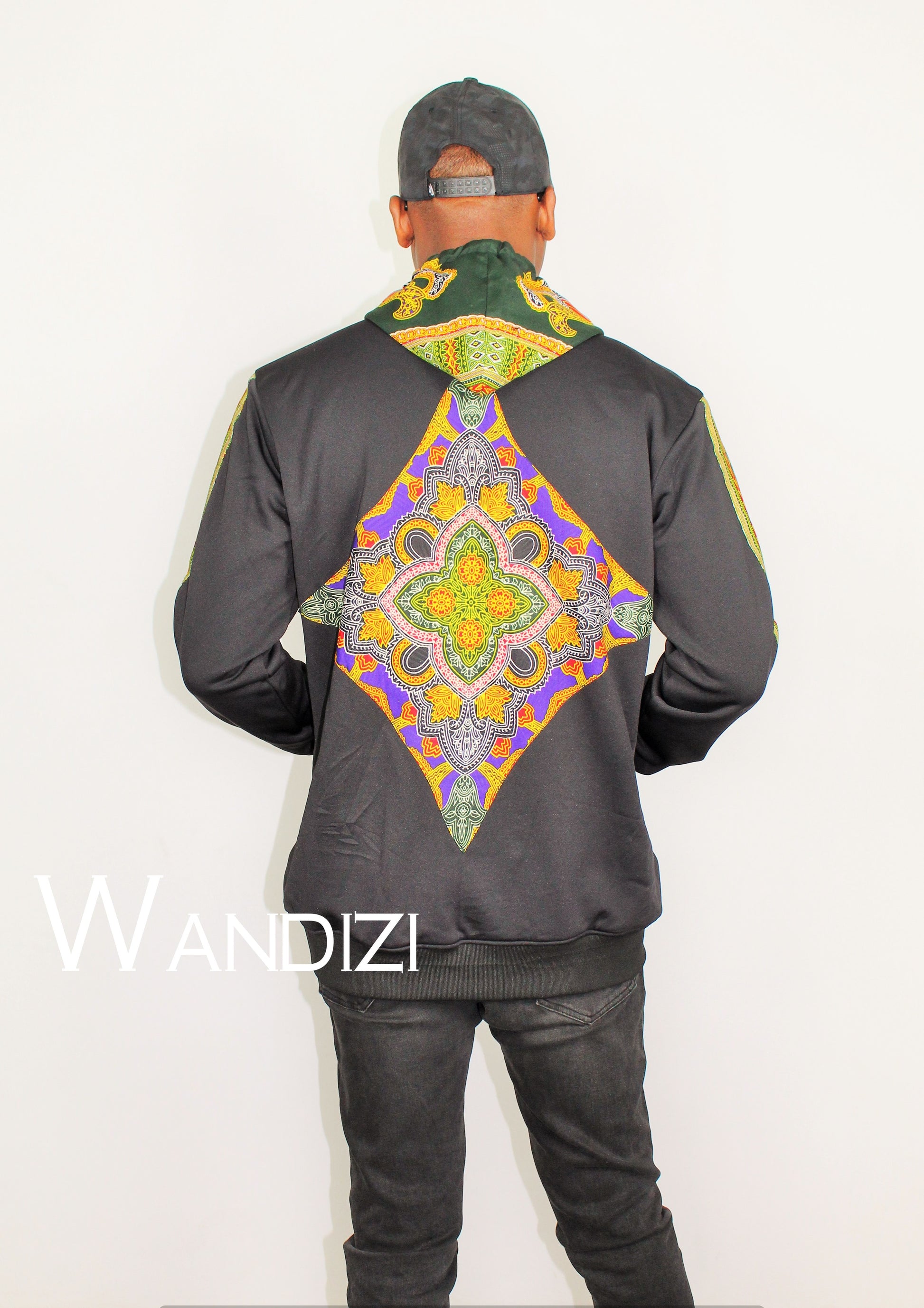 Dashiki Hoodie Jacket featuring a black body with a vibrant yellow, purple, and green traditional ornate pattern on the front bodice, kangaroo pocket, and outer sleeve lines