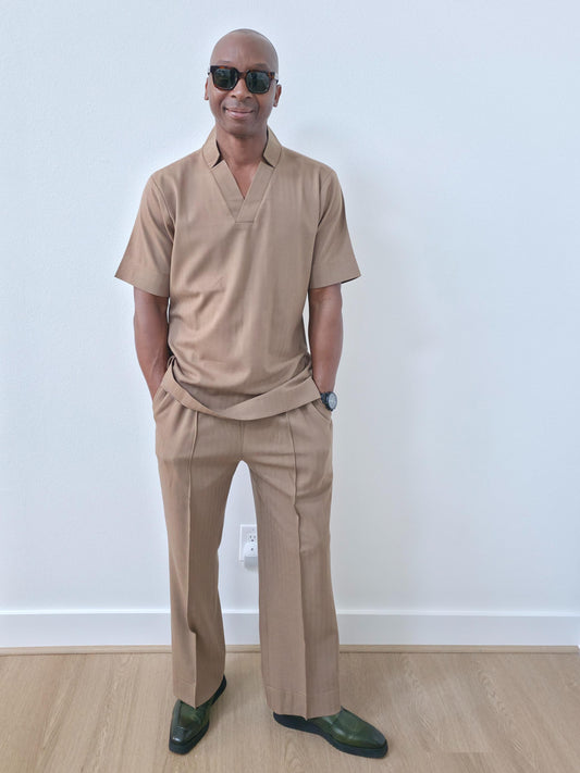 Dune caramel two-piece set featuring a short-sleeved V-neck tunic and matching straight-leg trousers with a sharp front crease. -Front View