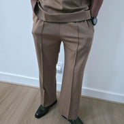 Dune caramel two-piece set featuring a short-sleeved V-neck tunic and matching straight-leg trousers with a sharp front crease. - Pants 