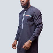 African Men's Suit featuring a longline navy blue tunic with a round neckline, a central vertical white placket detail accented by light blue and red threading, a matching decorated chest pocket welt, and tailored coordinating trousers
