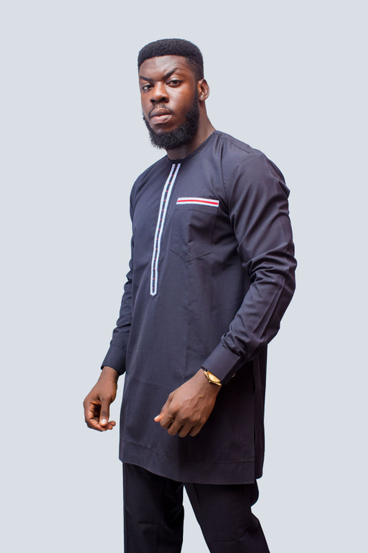African Men's Suit featuring a longline navy blue tunic with a round neckline, a central vertical white placket detail accented by light blue and red threading, a matching decorated chest pocket welt, and tailored coordinating trousers