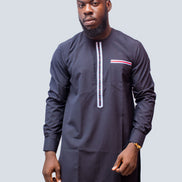 African Men's Suit featuring a longline navy blue tunic with a round neckline, a central vertical white placket detail accented by light blue and red threading, a matching decorated chest pocket welt, and tailored coordinating trousers
