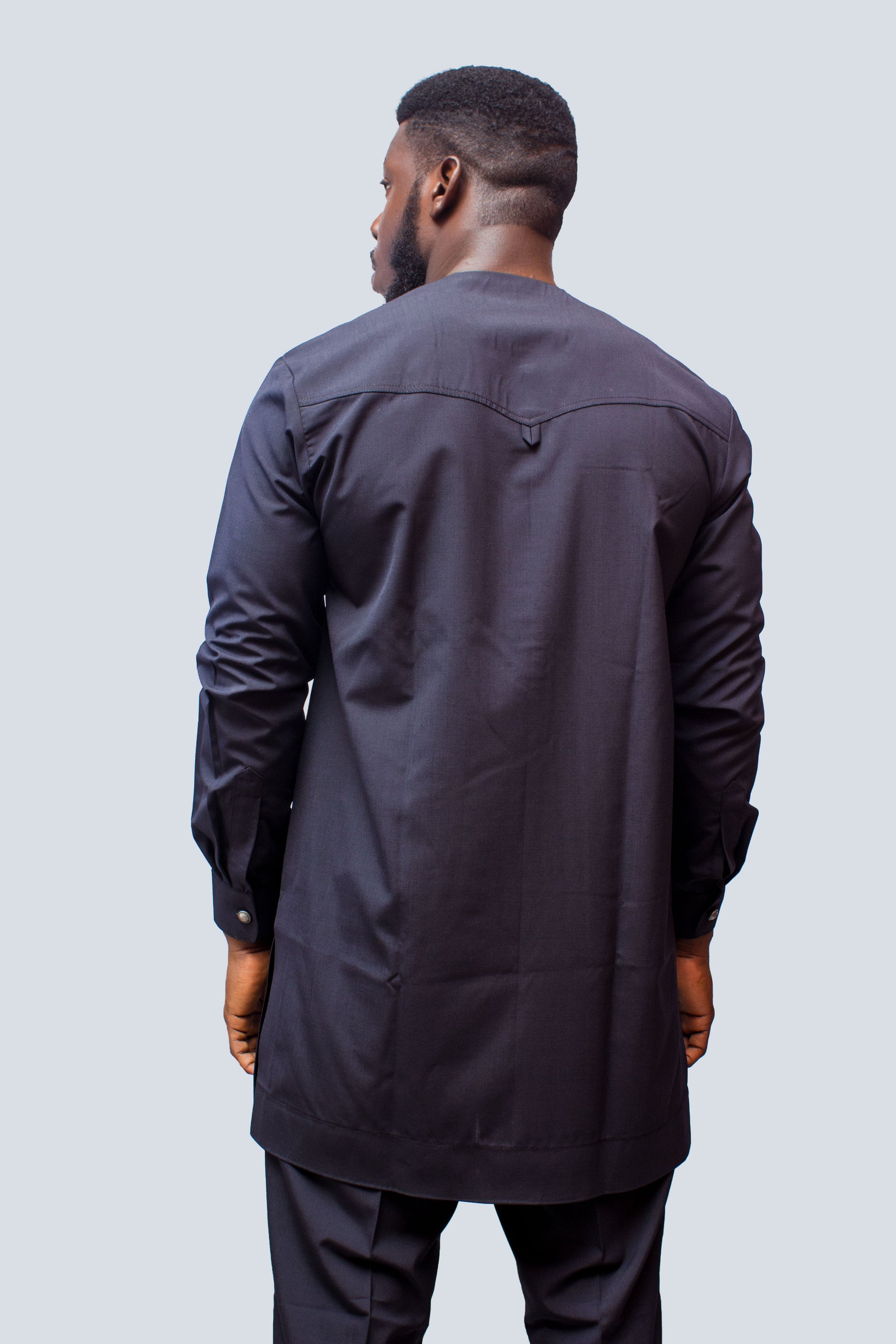 African Men's Suit featuring a longline navy blue tunic with a round neckline, a central vertical white placket detail accented by light blue and red threading, a matching decorated chest pocket welt, and tailored coordinating trousers