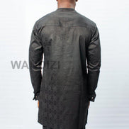 African Men's Suit featuring a longline black patterned jacquard tunic with a band collar, buttoned placket, a single patch pocket on the chest, and coordinating tailored trousers