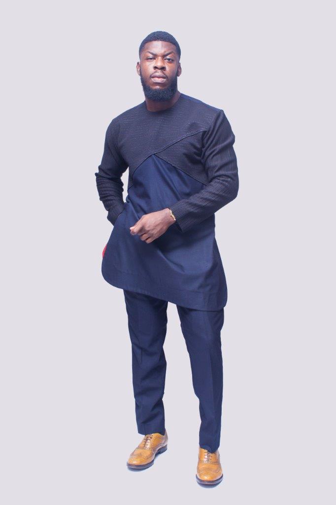 African Men's Suit featuring a longline dark tunic with a criss-cross textured black net fabric paneled across the upper chest and sleeves, paired with tailored coordinating trousers
