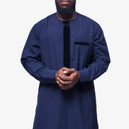 African Men's Suit featuring a longline deep blue tunic with a round neckline, a distinctive central vertical black velvet panel, a velvet-accented chest pocket, and tailored matching trousers