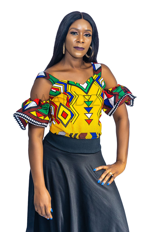 Ankara Top featuring a cold-shoulder crop silhouette with elasticated flare sleeves in a colorful geometric print with yellow, blue, red, and green diamond and triangle motifs