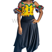 Ankara Top featuring a cold-shoulder crop silhouette with elasticated flare sleeves in a colorful geometric print with yellow, blue, red, and green diamond and triangle motifs