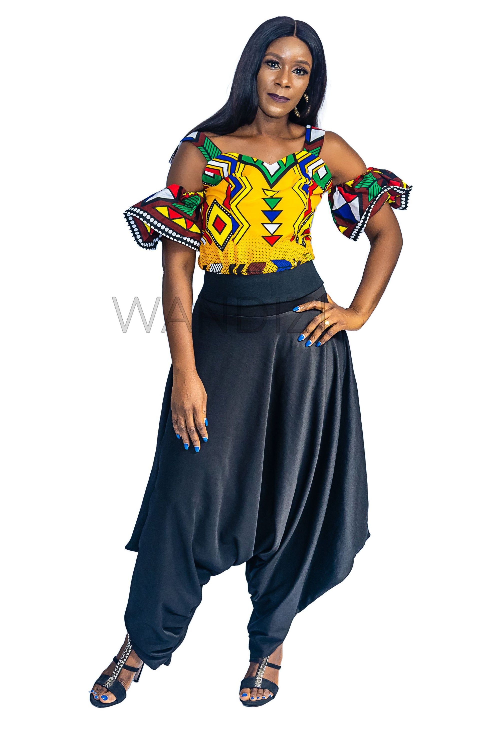 Ankara Top featuring a cold-shoulder crop silhouette with elasticated flare sleeves in a colorful geometric print with yellow, blue, red, and green diamond and triangle motifs