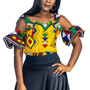 Ankara Top featuring a cold-shoulder crop silhouette with elasticated flare sleeves in a colorful geometric print with yellow, blue, red, and green diamond and triangle motifs