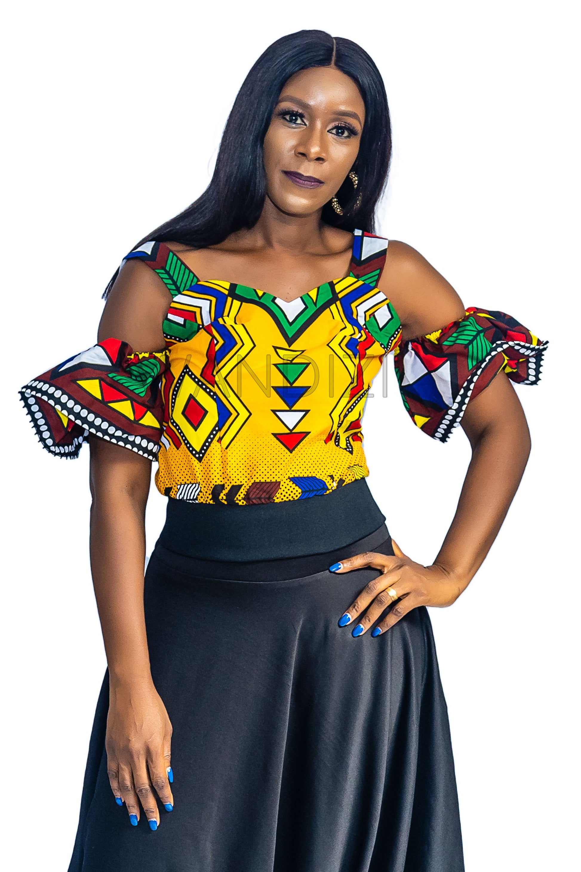 Ankara Top featuring a cold-shoulder crop silhouette with elasticated flare sleeves in a colorful geometric print with yellow, blue, red, and green diamond and triangle motifs