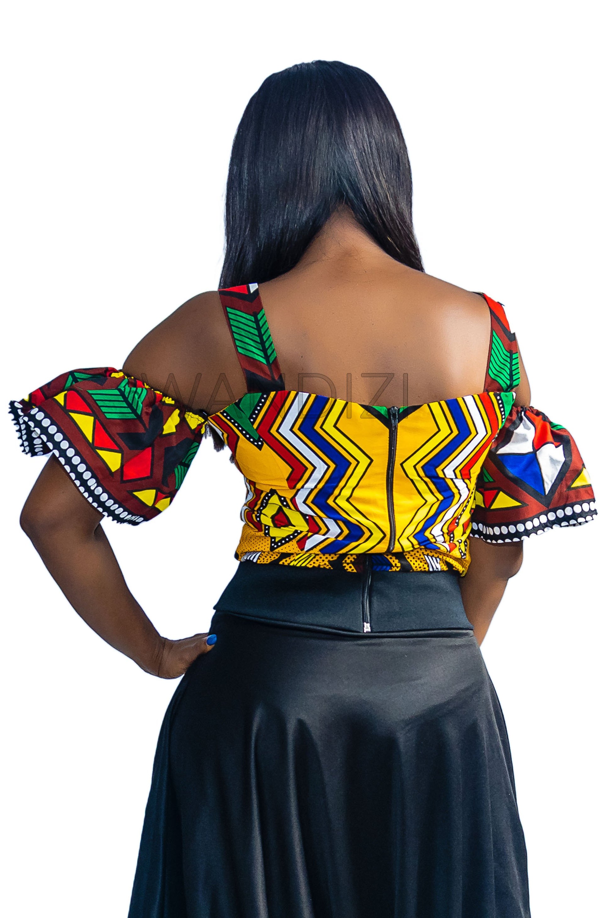 Ankara Top featuring a cold-shoulder crop silhouette with elasticated flare sleeves in a colorful geometric print with yellow, blue, red, and green diamond and triangle motifs