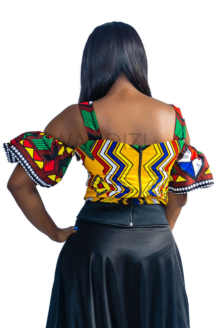Ankara Top featuring a cold-shoulder crop silhouette with elasticated flare sleeves in a colorful geometric print with yellow, blue, red, and green diamond and triangle motifs