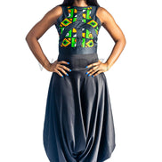 Ankara Top featuring a sleeveless, high-neck crop silhouette with a vibrant green, orange, and yellow geometric print paneled with broad black structural borders