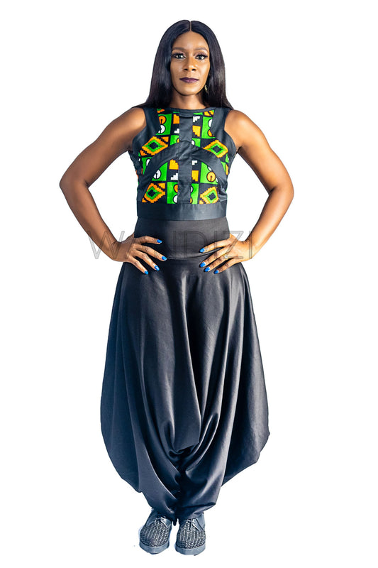 Ankara Top featuring a sleeveless, high-neck crop silhouette with a vibrant green, orange, and yellow geometric print paneled with broad black structural borders