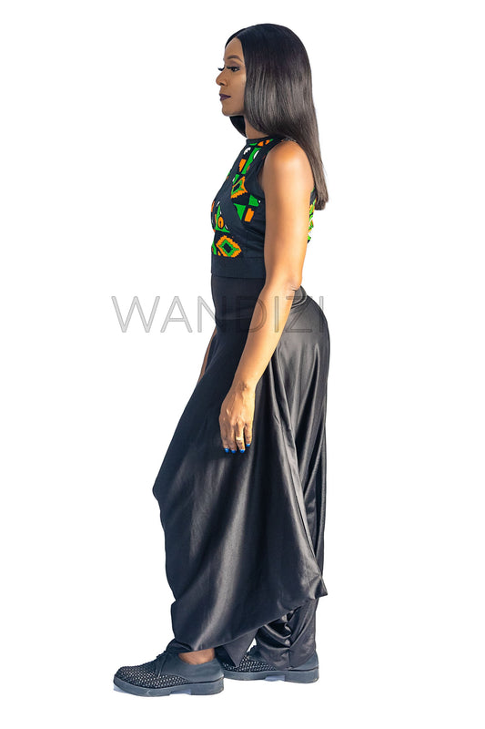 Ankara Top featuring a sleeveless, high-neck crop silhouette with a vibrant green, orange, and yellow geometric print paneled with broad black structural borders