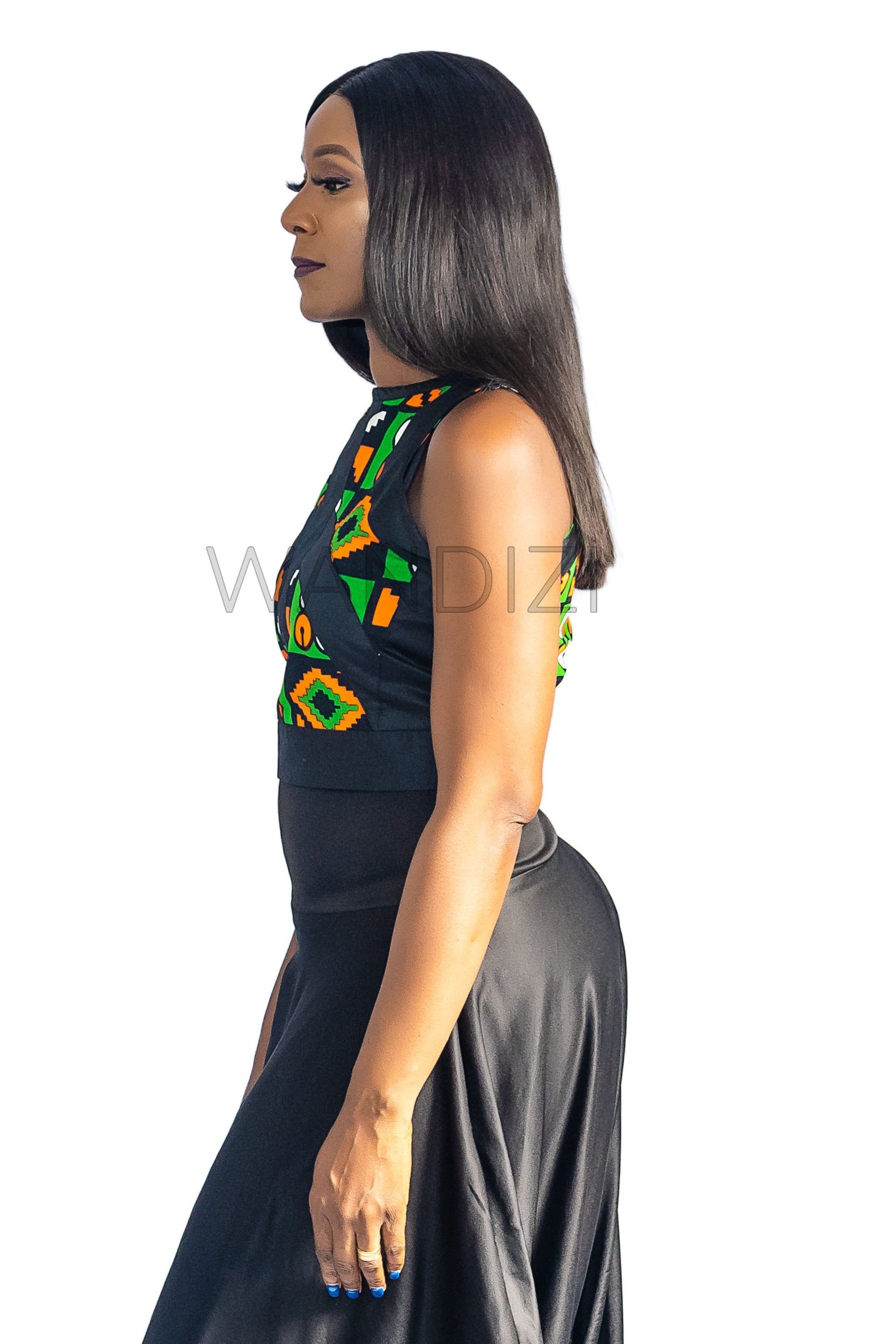 Ankara Top featuring a sleeveless, high-neck crop silhouette with a vibrant green, orange, and yellow geometric print paneled with broad black structural borders