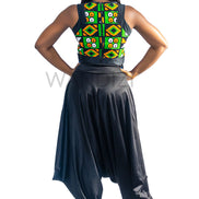 Ankara Top featuring a sleeveless, high-neck crop silhouette with a vibrant green, orange, and yellow geometric print paneled with broad black structural borders