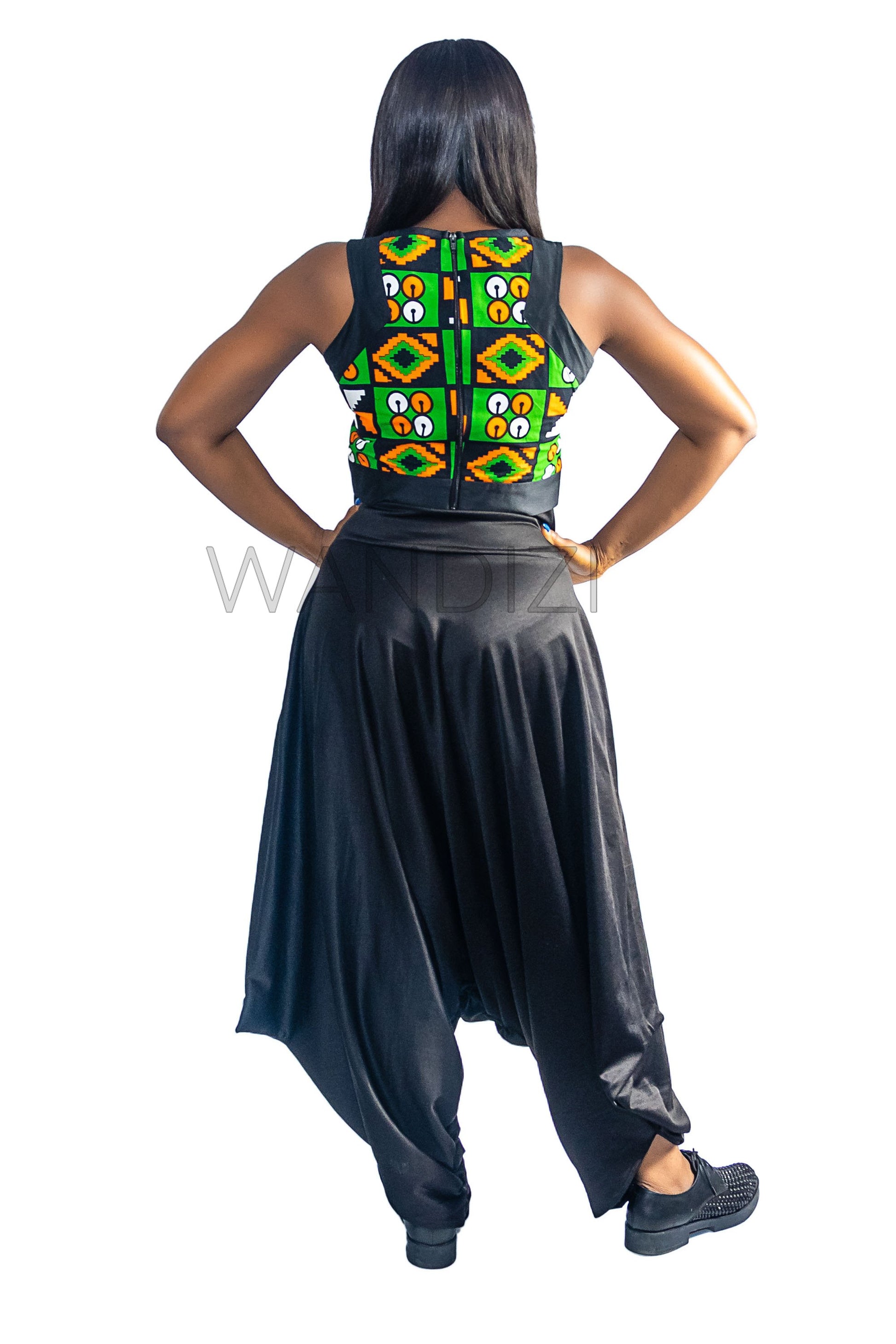 Ankara Top featuring a sleeveless, high-neck crop silhouette with a vibrant green, orange, and yellow geometric print paneled with broad black structural borders