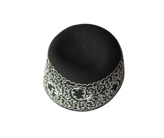 Awo Cap featuring a black velvet body with an intricate white scrolling and maze-like embroidered border