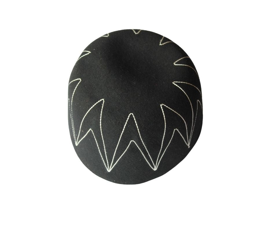 Awo Cap featuring a black wool body with white zigzag zenith stitching