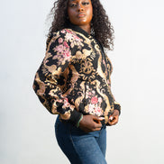 Gilded Rose Floral Bomber Jacket  featuring a black velvet-texture fabric with intricate pink rose and gold scrollwork patterns. Side View