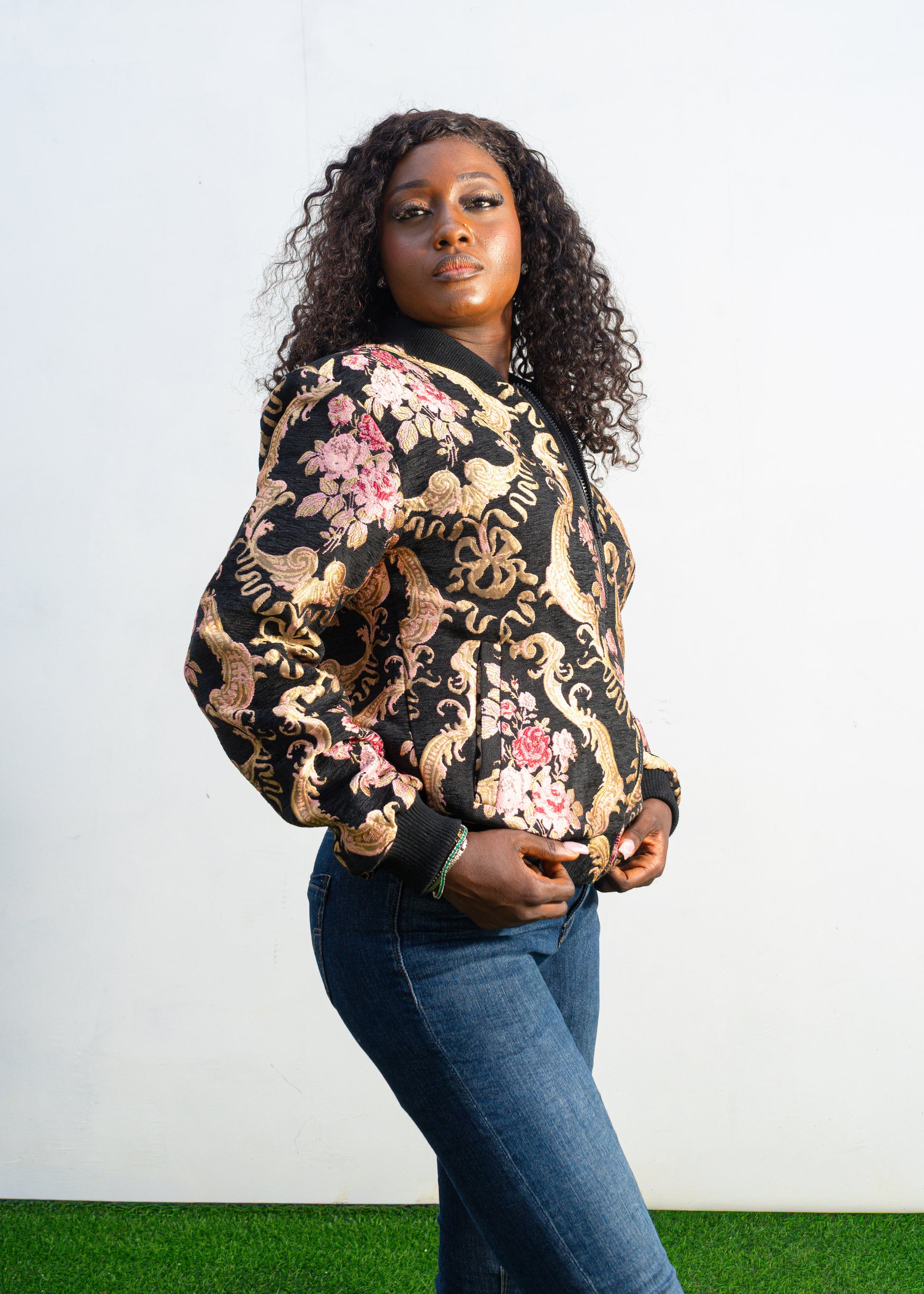 Gilded Rose Floral Bomber Jacket  featuring a black velvet-texture fabric with intricate pink rose and gold scrollwork patterns. Side View