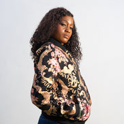 Gilded Rose Floral Bomber Jacket featuring a black velvet-texture fabric with intricate pink rose and gold scrollwork patterns. Side View