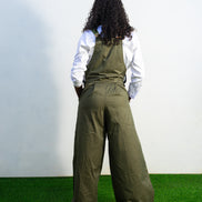 Verdant Patchwork Cotton Jumpsuit featuring wide-leg olive trousers and a bib panel with green, black, and orange vertical stripes. Back View