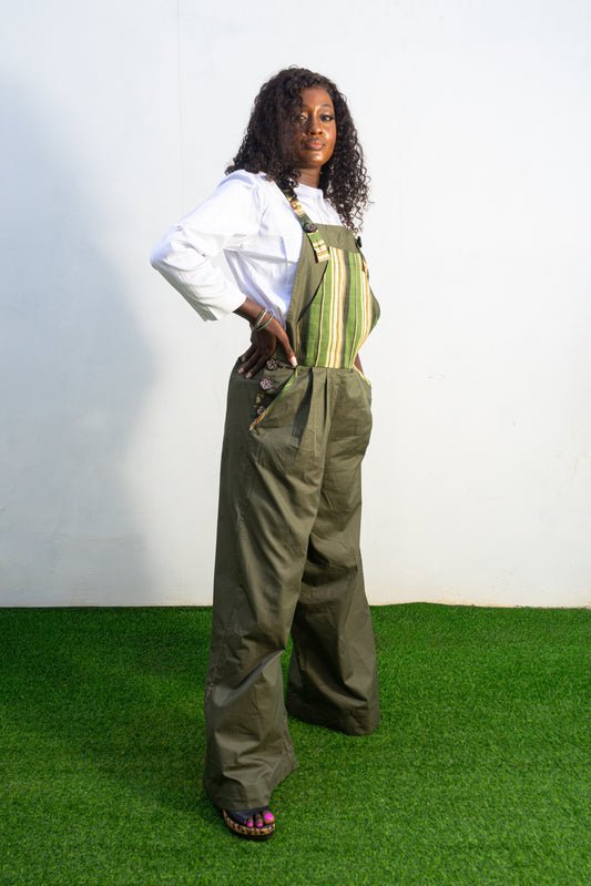 Verdant Patchwork Cotton Jumpsuit featuring wide-leg olive trousers and a bib panel with green, black, and orange vertical stripes. Side View