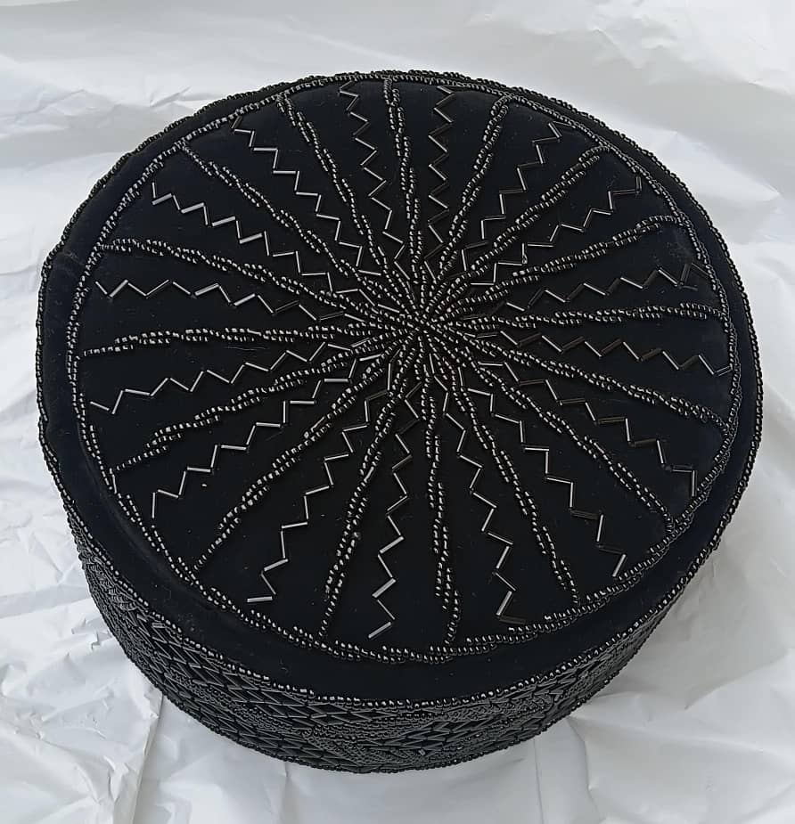 Crown Cap featuring rich black velvet adorned with intricate, hand-stitched black beadwork in starburst and geometric lattice patterns.