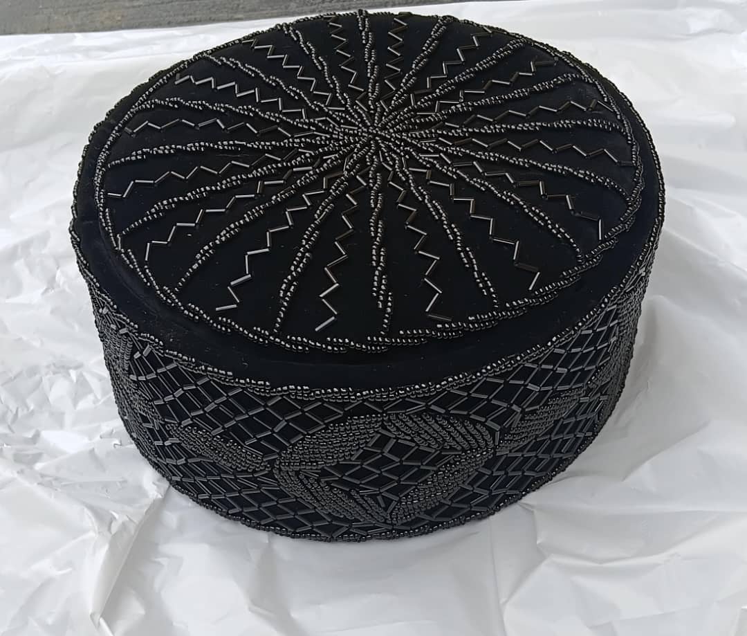 Crown Cap featuring rich black velvet adorned with intricate, hand-stitched black beadwork in starburst and geometric lattice patterns.