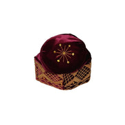 Fila Cap featuring burgundy velvet with a gold starburst on the crown and a geometric lattice embroidery pattern around the base.