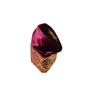 Fila Cap featuring burgundy velvet with a gold starburst on the crown and a geometric lattice embroidery pattern around the base.
