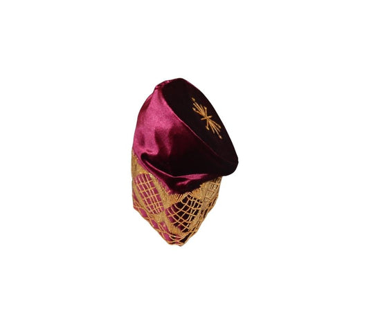 Fila Cap featuring burgundy velvet with a gold starburst on the crown and a geometric lattice embroidery pattern around the base.