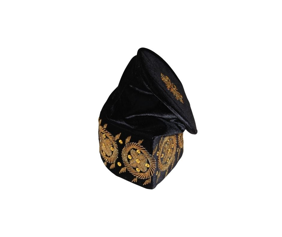 Fila Cap featuring solid black velvet with a central gold starburst and a series of circular gold floral motifs embroidered around the base.