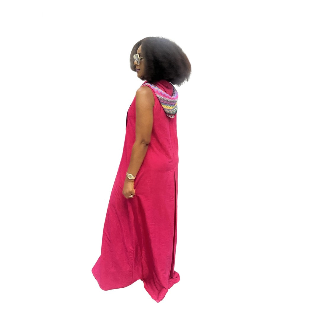Sleeveless fuchsia maxi dress featuring a front zipper, side pockets, and a hoodie with a multicolor patterned lining.
