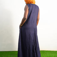 Orange and black Diamond Patterned Jumpsuit featuring a sleeveless black frame with large orange diamond-shaped patchwork across the front and an attached hood. Back View