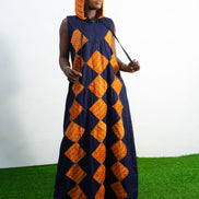 Orange and black Diamond Patterned Jumpsuit featuring a sleeveless black frame with large orange diamond-shaped patchwork across the front and an attached hood. Hoody On