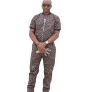 Short-sleeved jumpsuit featuring a brown and black animal print, a silver front zipper, and black ribbed cuffs