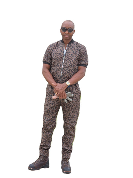 Short-sleeved jumpsuit featuring a brown and black animal print, a silver front zipper, and black ribbed cuffs