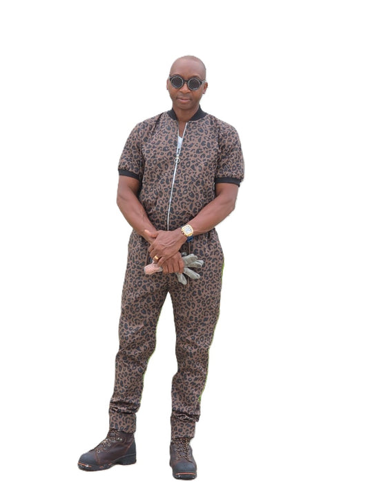 Short-sleeved jumpsuit featuring a brown and black animal print, a silver front zipper, and black ribbed cuffs