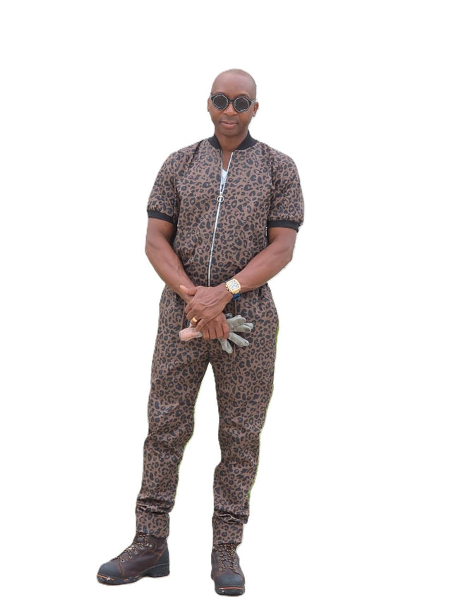 Short-sleeved jumpsuit featuring a brown and black animal print, a silver front zipper, and black ribbed cuffs
