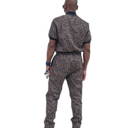 Short-sleeved jumpsuit featuring a brown and black animal print, a silver front zipper, and black ribbed cuffs
