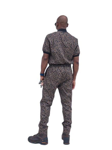 Short-sleeved jumpsuit featuring a brown and black animal print, a silver front zipper, and black ribbed cuffs