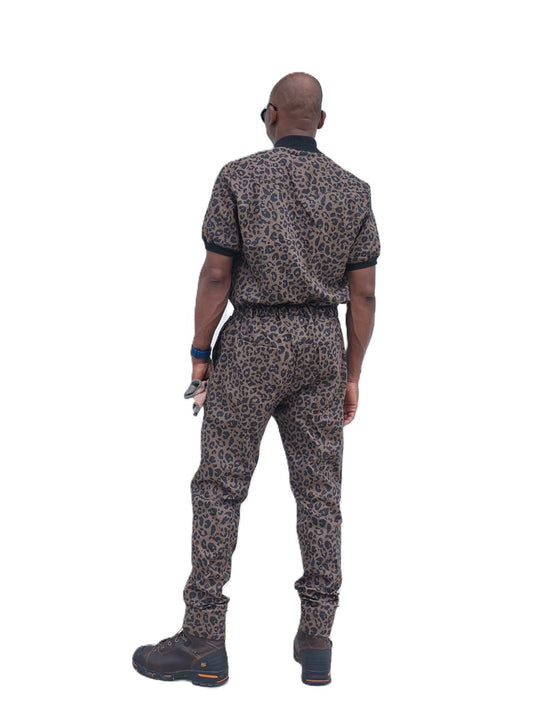 Short-sleeved jumpsuit featuring a brown and black animal print, a silver front zipper, and black ribbed cuffs