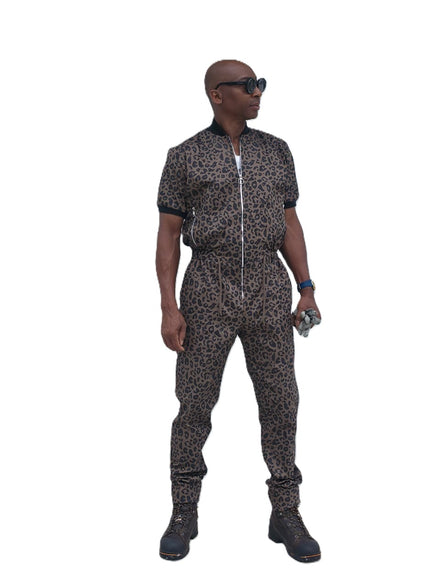 Short-sleeved jumpsuit featuring a brown and black animal print, a silver front zipper, and black ribbed cuffs