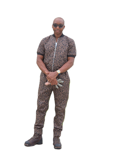 Short-sleeved jumpsuit featuring a brown and black animal print, a silver front zipper, and black ribbed cuffs