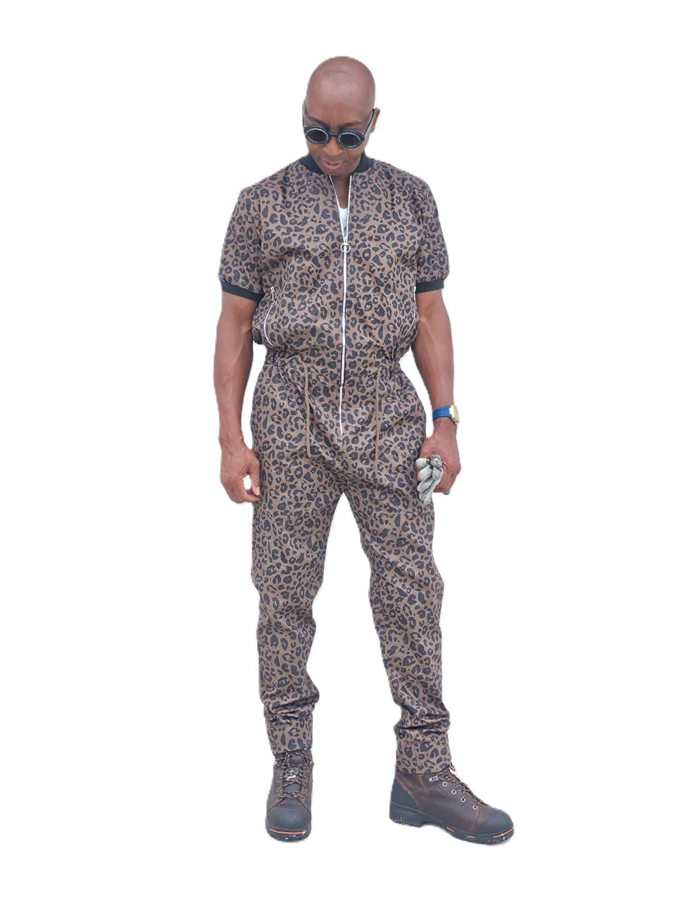Short-sleeved jumpsuit featuring a brown and black animal print, a silver front zipper, and black ribbed cuffs