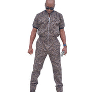 Short-sleeved jumpsuit featuring a brown and black animal print, a silver front zipper, and black ribbed cuffs